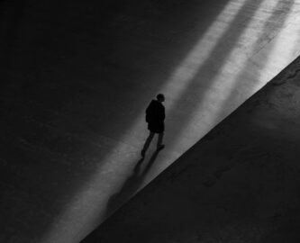 person walking in shadows